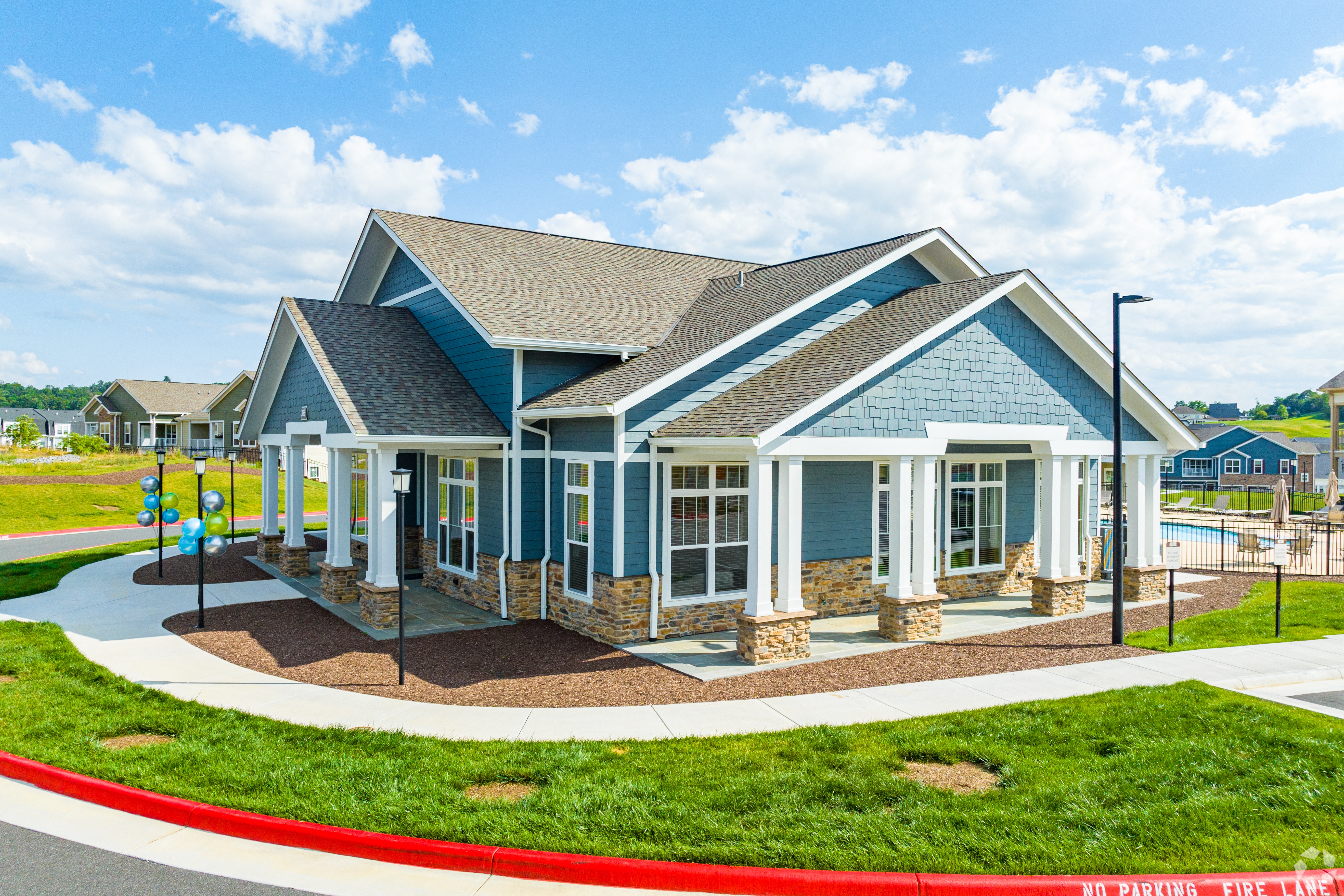 a blue house with a porch and a playground